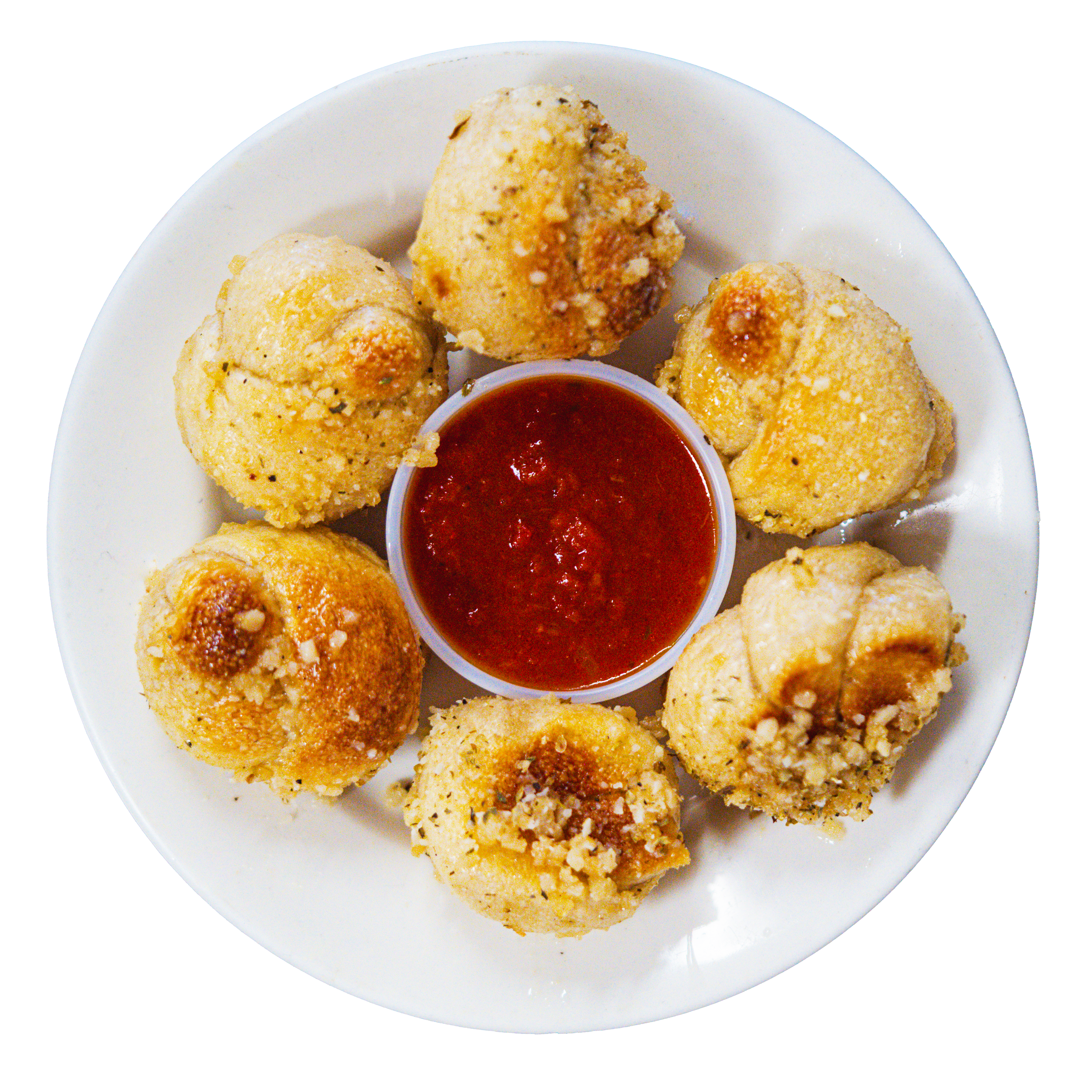Six garlic knots on a plate with marinara dipping sauce in the middle.